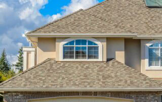 new shingle roof instalation Close-up of a residential roof with asphalt shingles and a large arched window.
