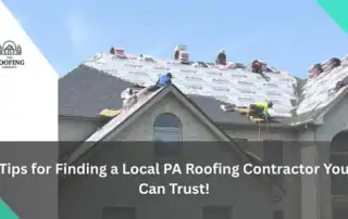 Roofing workers installing new shingles on a residential roof in Pittsburgh.
