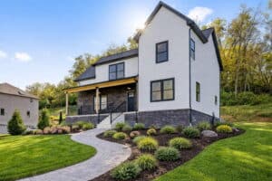 siding_1769533119483-DSNGXKv4 (1) Modern white house with black trim and a landscaped yard in Pittsburgh.