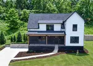 Newly installed black shingle roof on a white two-story home in Pennsylvania.