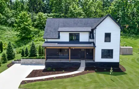 Newly installed black shingle roof on a white two-story home in Pennsylvania.